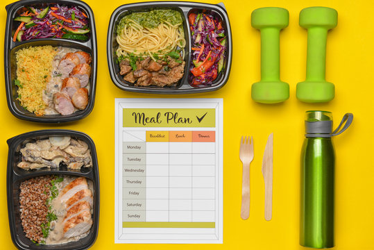 Containers with healthy food, bottle of water, dumbbells and meal plan on color background