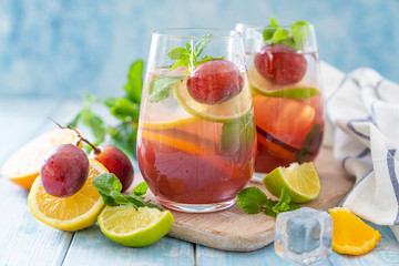 Sangria and ingredients on blue wood background, summer, copy space