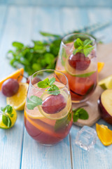 Sangria and ingredients on blue wood background, summer, copy space