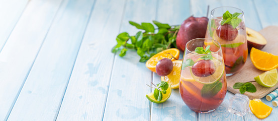 Sangria and ingredients on blue wood background, summer, copy space