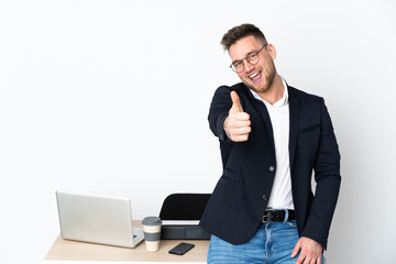 Russian man in a office isolated on white background with thumbs up because something good has happened