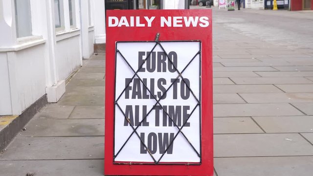 4K: Newspaper Headline Board about the Euro falling to all time low on the Stock Exchange - News stand. Stock Video Clip Footage