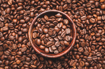 Bowl on roasted coffee beans