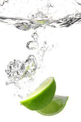Fototapeta na wymiar Falling of fresh cut lime into water against white background