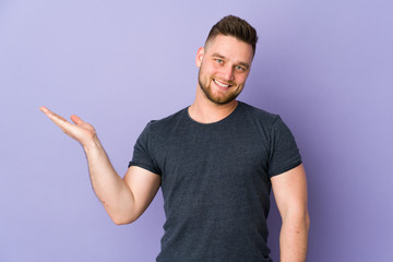 Russian handsome man over isolated background holding copyspace imaginary on the palm to insert an...