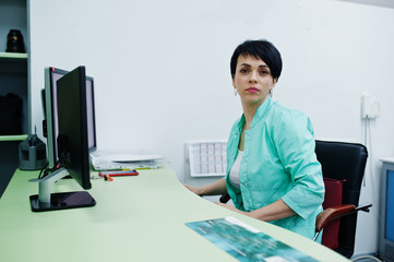 Medical theme. Doctor in the mri office at diagnostic center in hospital, sitting near monitors of...