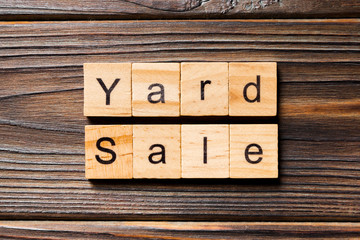 Yard sale word written on wood block. Yard sale text on wooden table for your desing, Top view concept