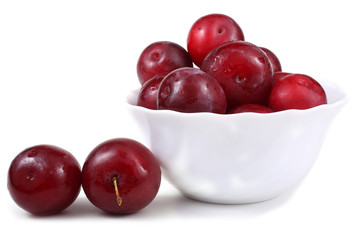 Red plums on dish