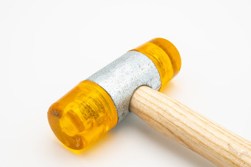 A small orange rubber mallet lying on a white background
