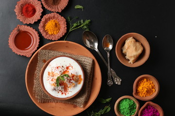 Dahi vada is Indian chaat Fast food of india popular for Holi. served in earthen bowl. Holi food concept