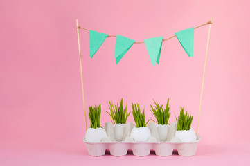 Easter concept with eggs  on a pink background. Eggshell grass, spring, Easter. Festive concept close-up and copy space on a pink background.