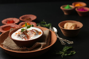 Dahi vada (Deep fried balls served with curd), thandai are well known indian Holi snack. (Holi Concept)