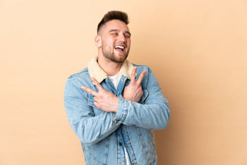 Russian handsome man over isolated background smiling and showing victory sign