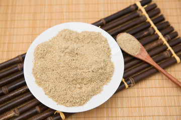 A pile of rice bran in a bamboo basket