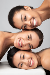 Three Multicultural Ladies Posing Over Gray Background, Beauty Portrait, Vertical - obrazy, fototapety, plakaty
