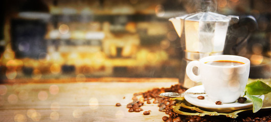 Coffee cup and beans on old kitchen table.