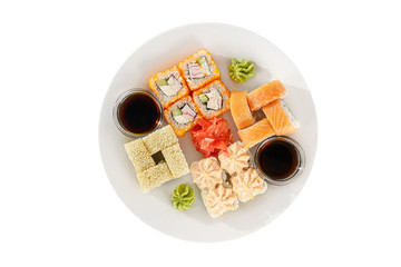 Set of sushi, rolls, uramaki, hosomaki california and philadelphia, lava sauce, marinated ginger and wasabi, white isolated background, view from above