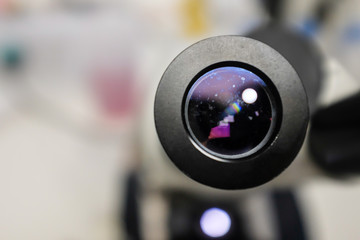 Close-up shot of microscope with metal lens at laboratory.  Chemistry and science research concept background.