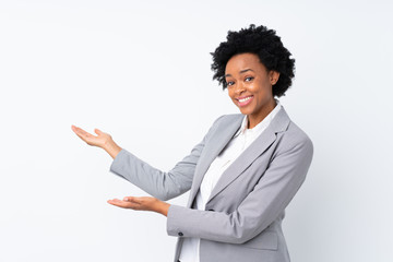 African american business woman over isolated white background extending hands to the side for inviting to come