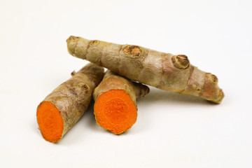 Fresh turmeric root, isolated on a white background, is an ingredient in turmeric foods and...
