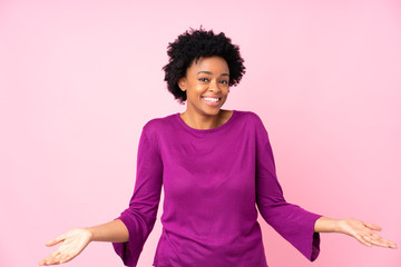 African american woman over isolated pink background smiling