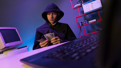 hacker in the hood near the computer