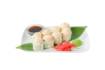 Sushi, rolls, uramaki, alaska with lava sauce, tobiko caviar, raw seafood, soy sauce, marinated ginger and wasabi. Food on a banana leaf, on plate, white isolated background, side view
