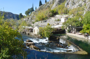 Fototapeta na wymiar Blagaj Tekija: Bosnia's Beautiful Monastery Under A Cliff. It situated next to the source of the river Buna. The Tekija was first founded during the height of the Ottoma