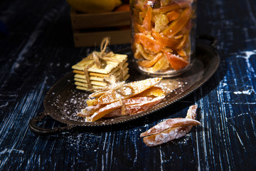 Homemade candied peels orange confiture in glass jar with spices