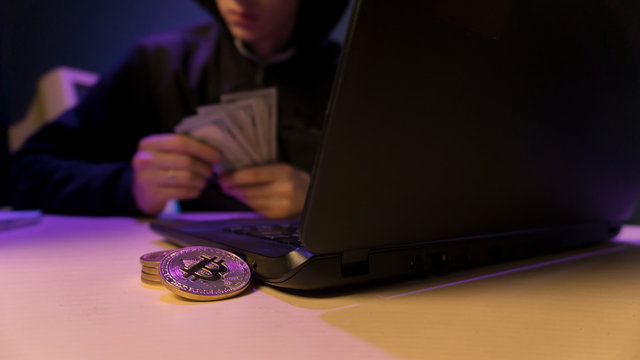 Bitcoin coins and dollars on the table