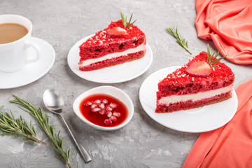 Homemade red velvet cake with milk cream and strawberry  with cup of coffee on a gray concrete background. side view.