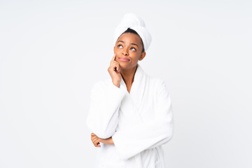 African american woman  in a bathrobe over isolated background thinking an idea
