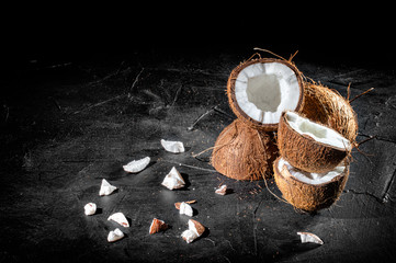 Coconut with half on dark background