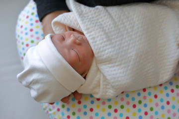 innocence face of cute baby newborn close eye sleeping in white blanket childhood