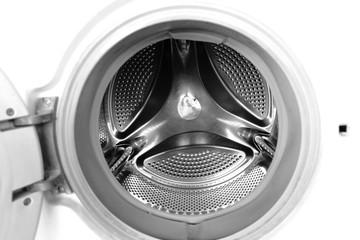 Washing machine drum interior. Perforated stainless steel drum for automatic washing machine. Black and white, metallic background,texture