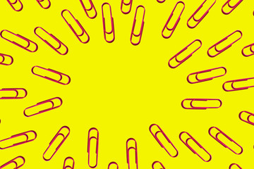 pink paper clips on yellow background