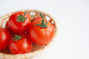 Ripe tomatoes in a wicker basket