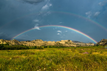 Fototapeta na wymiar Double rainbow over the hills