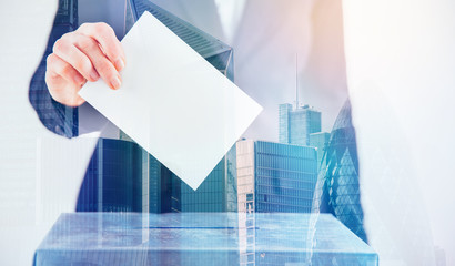 Double exposure image of voter putting ballot into voting box and buildings. Business and election concept. 