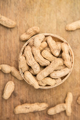 A pile of peanuts in a bamboo basket