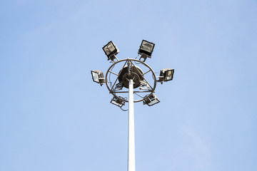 Sport lights in sport stadium on blue sky background