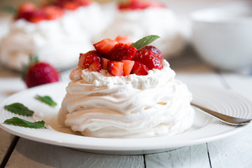 Delicious Pavlova cake with meringue and fresh strawberries