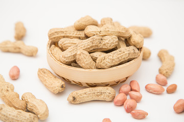 A pile of peanuts in a bamboo basket