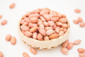 A pile of peanuts in a bamboo basket