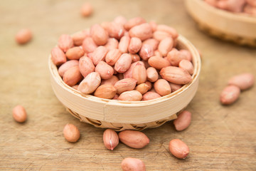 A pile of peanuts in a bamboo basket