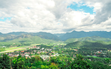 The landscape of Mae Hong Son province, Thailand has a small town in the valley. Behind the scenes are a complex mountain and a beautiful sky.