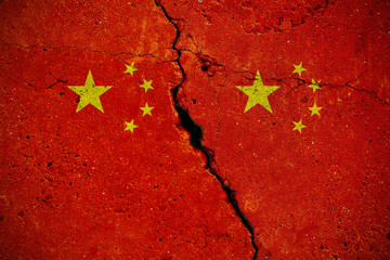 Concrete slab with large cracks and two flags of China. Abstract concept of the internal split of the state and civil war. Background