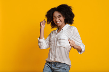 Euphoric Black Girl Celebrating Success, Raising Hands With Clenched Fists