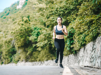 Asian fitness woman runner stretching legs before run outdoor workout in the park. Healthy Concept