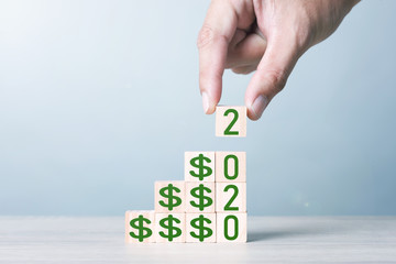 Wood block cubic stacking step up with green Dollar Sign Blue Tone. Business growth success process. Business Concept. Up Trend. 2020